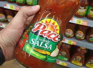 blog man holding bottle of pace brand salsa